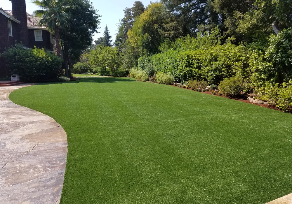 artificial grass front lawn with trees in the background